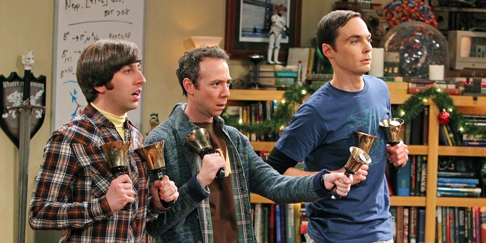 The Big Bang Theory's Sheldon, Howard, and Stuart holding bells.