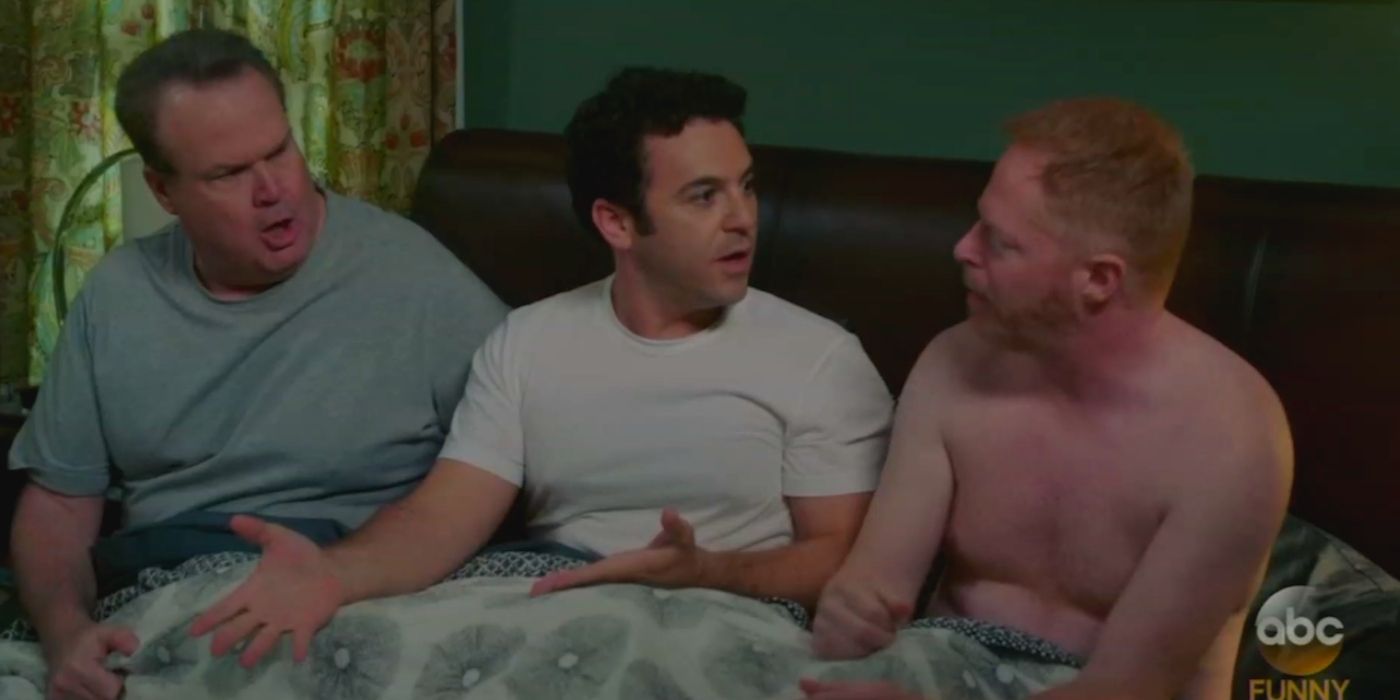 mitch in bed with cam and the Masseuse - modern family