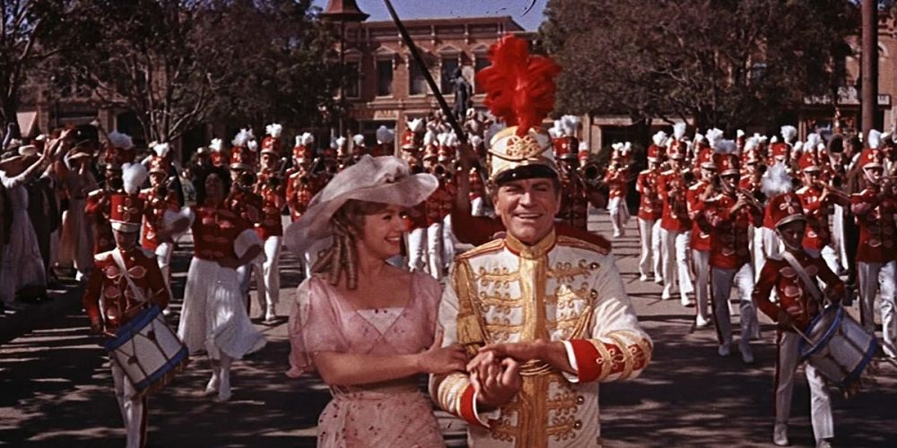Marian and Harold lead the band down the street in The Music Man