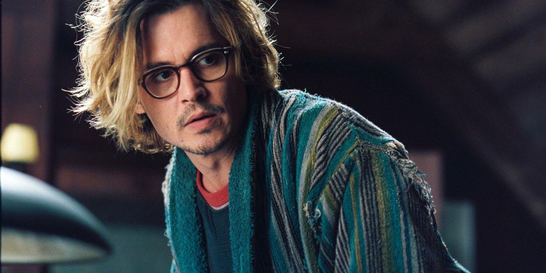Johnny Depp in The Secret Window wearing a robe and glasses and looking off to the side.