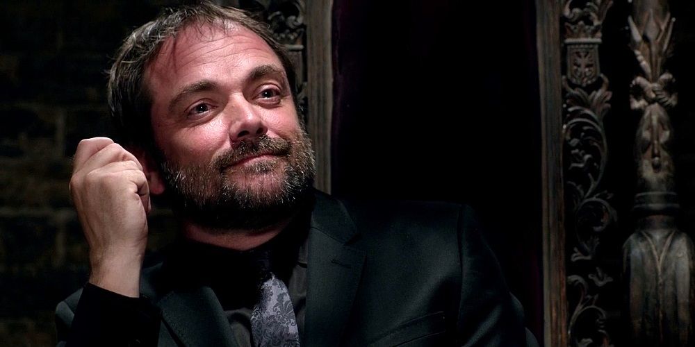 Crowley sits on his throne as king of hell in Supernatural