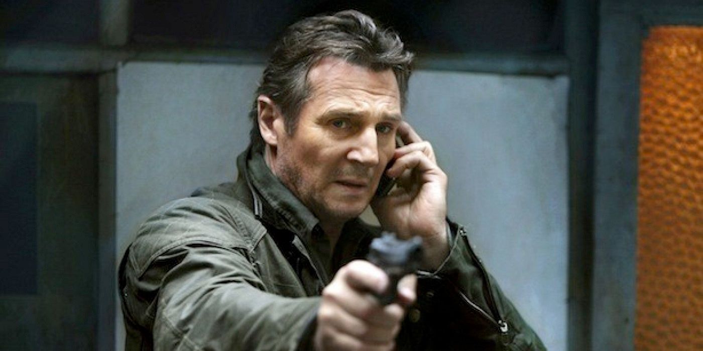 Bryan Mills pointing a gun while on the phone