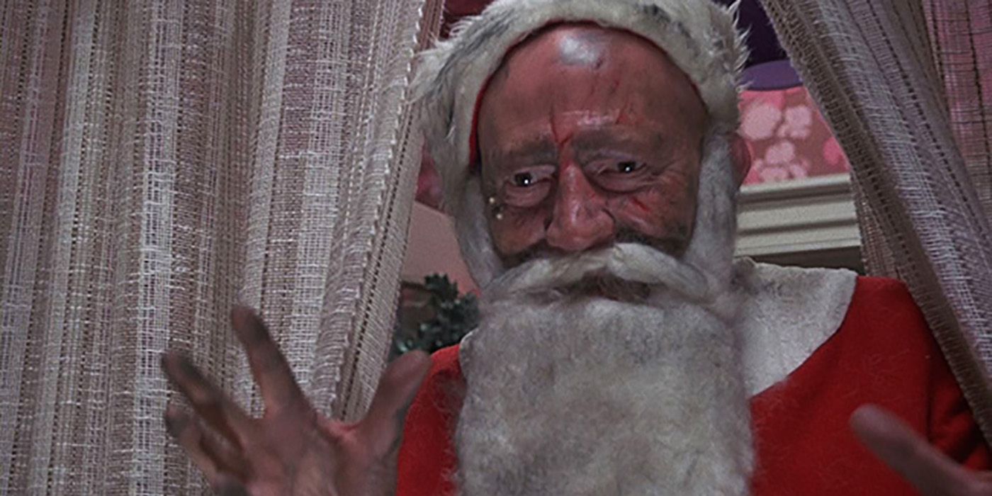 A scary man dressed as Santa with hands out in Tales From the Crypt