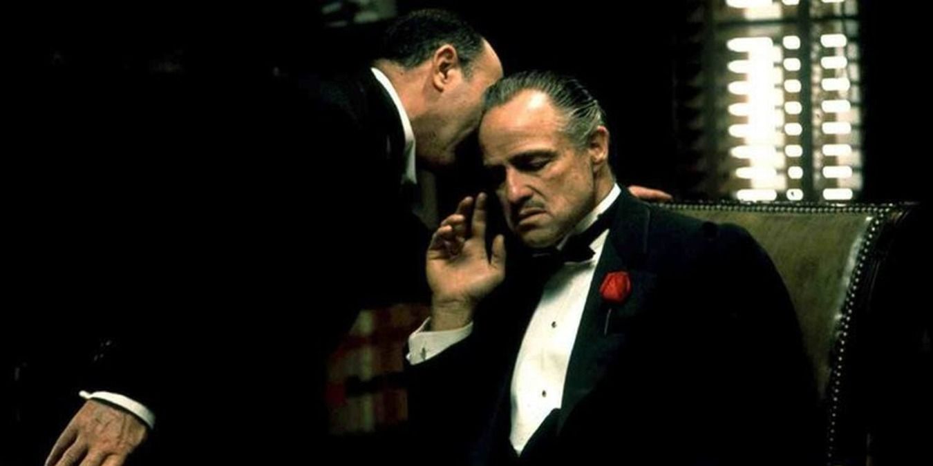 Marlon Brando gets told a secret in The Godfather.