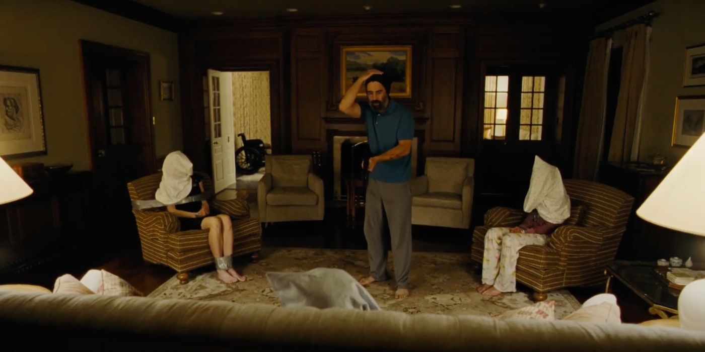 The family with bags over their heads at the end of killing of a sacred deer.