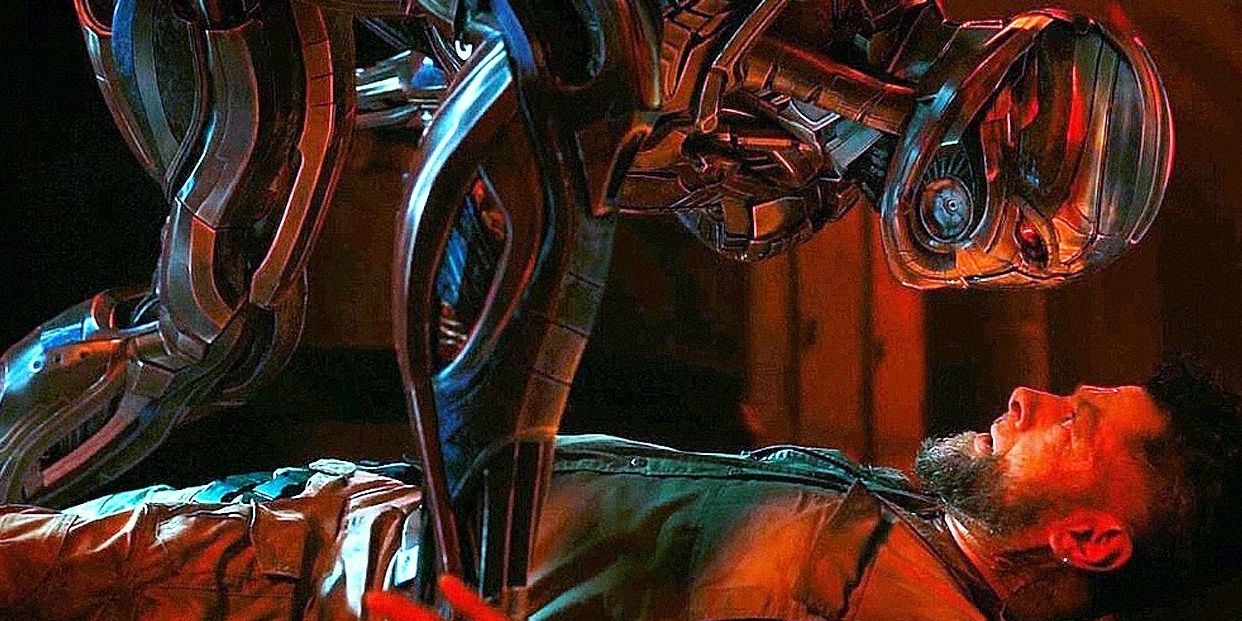 Ultron crouches over Klaue looking in his face