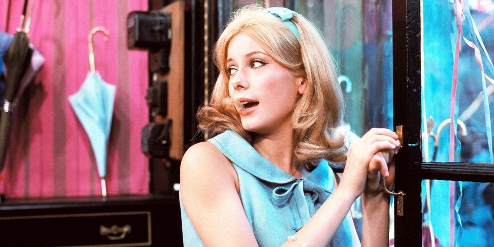 Genevieve sings as she enters a shop in The Umbrellas of Cherbourg
