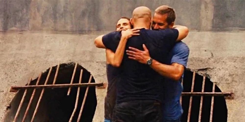 Dom, Brian, and Mia hug in Fast Five