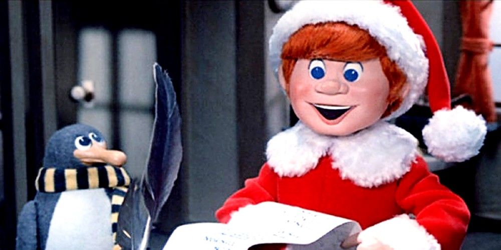 Kris Kringle como um jovem lendo uma lista com um pinguim em Papai Noel está vindo para a cidade