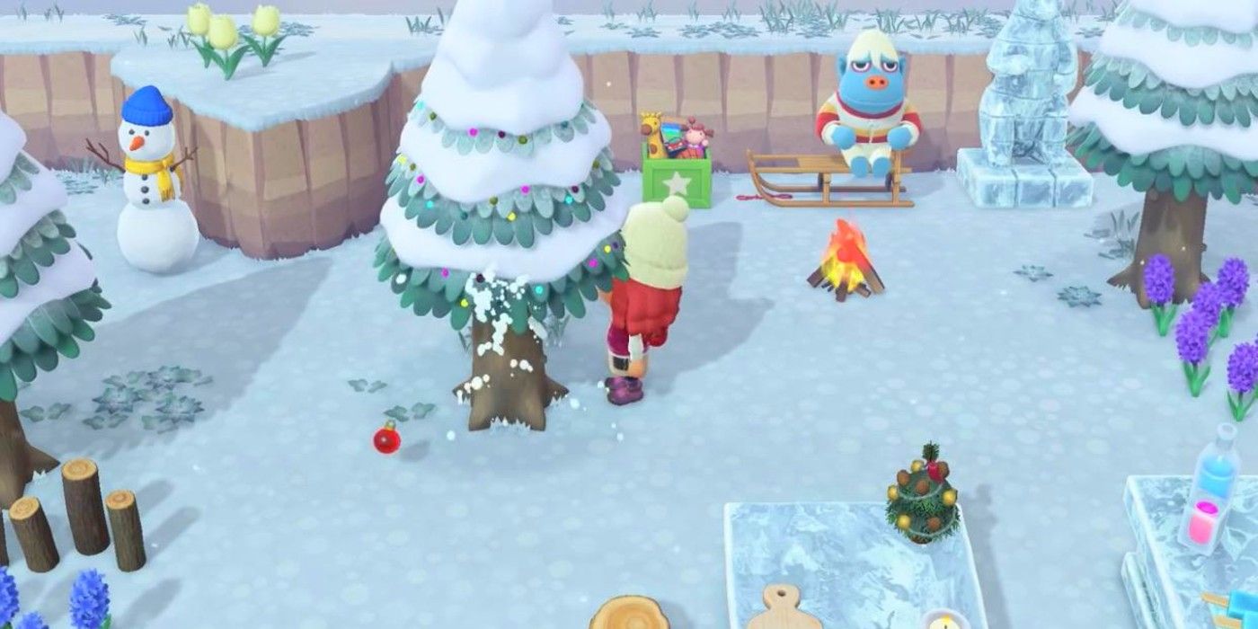 A player shakes their tree to get a red ornament in Animal Crossing: New Horizons