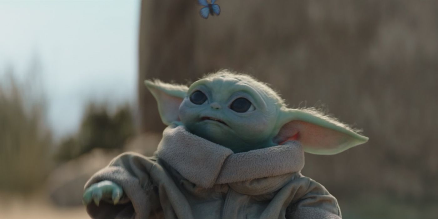 Baby Yoda with a butterfly in The Mandalorian