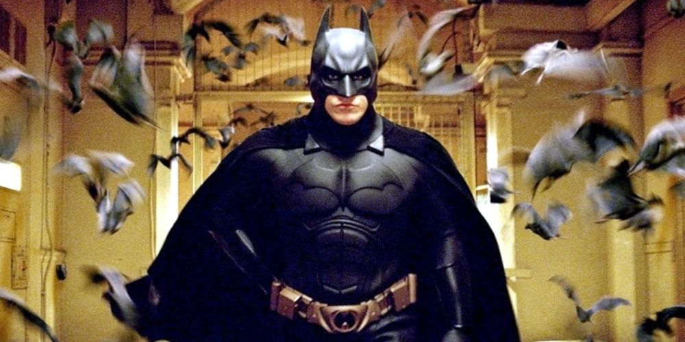 Batman surrounded by bats at Arkham in Batman Begins