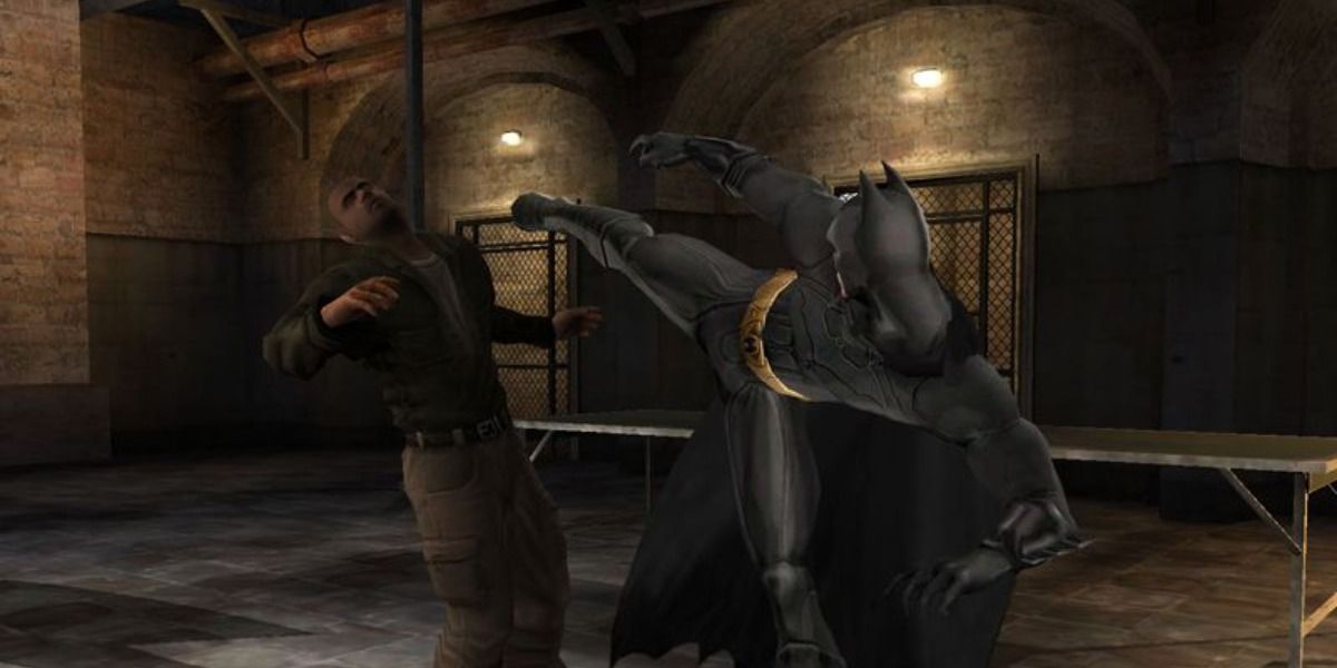 Batman kicking a bad guy in the Batman Begins video game 2005