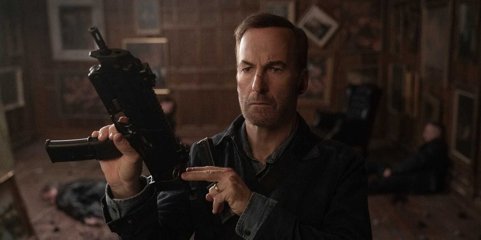 Bob Odenkirk as Hutch holding a gun in Nobody Movie