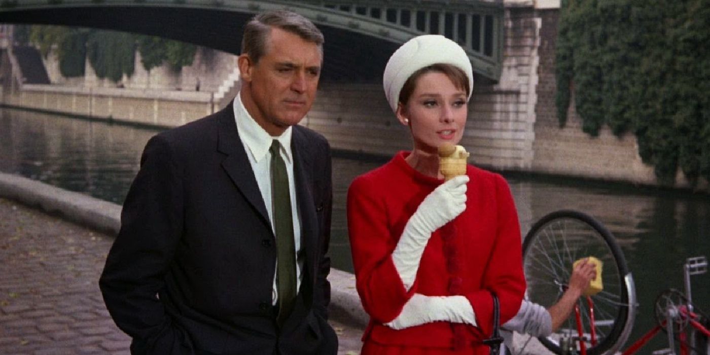 Cary Grant and Audrey Hepburn looking sideways while walking together in Charade