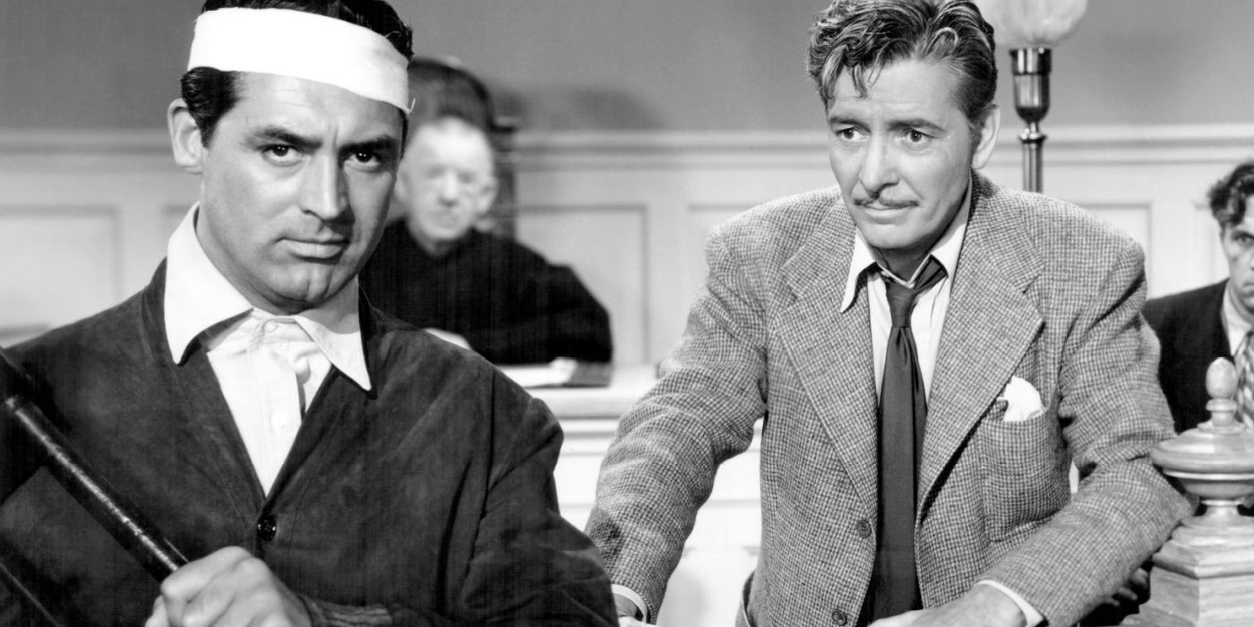 A bandaged Cary Grant sits in a courtwoom with Ronald Colman in The Talk of the Town.