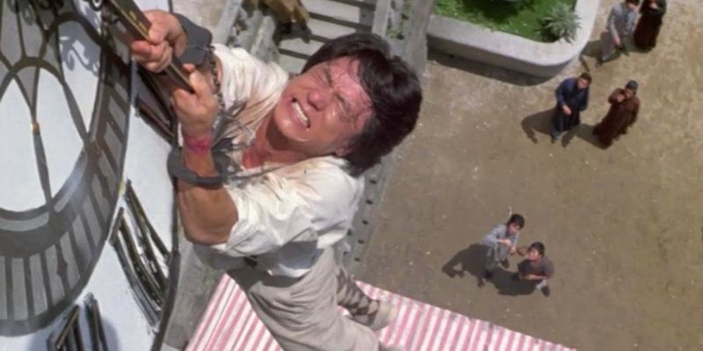 Jackie Chan hanging from a clock in Project A