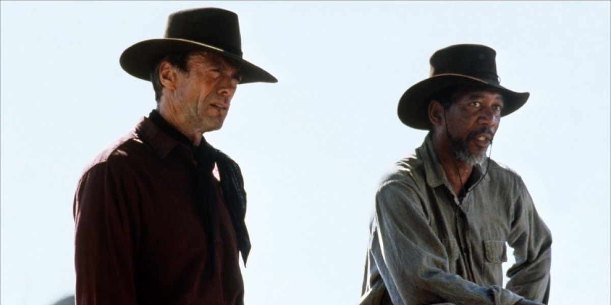 Clint Eastwood and Morgan Freeman standing in old fashioned costumes in Unforgiven