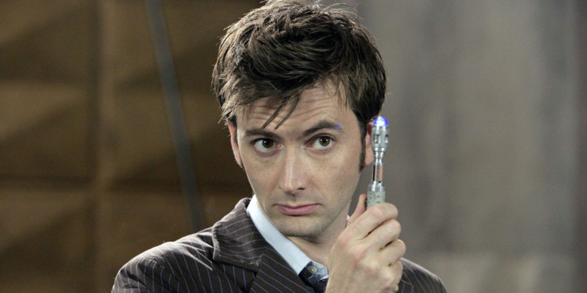The Tenth Doctor raising a device in Doctor Who