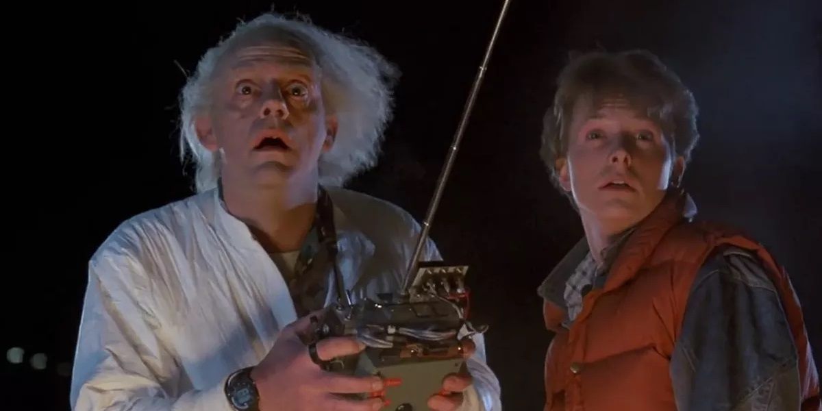 Doc and Marty look at the camera at night in Back to the Future