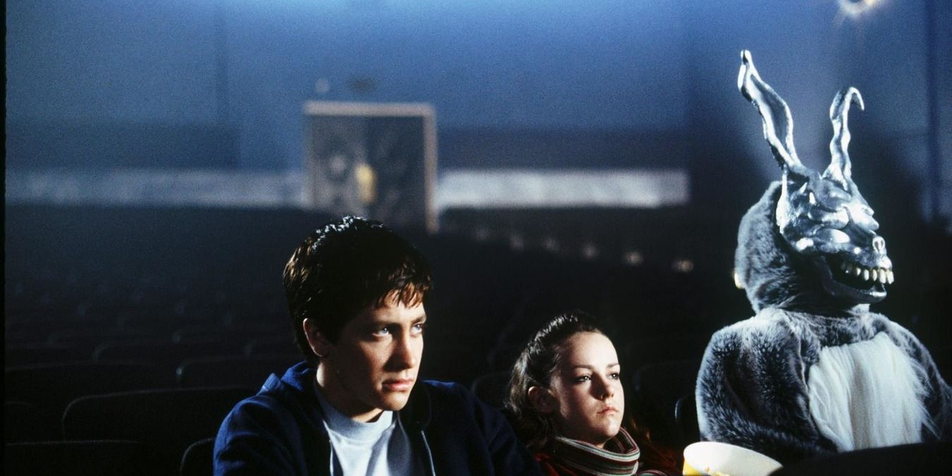 Donnie, Gretchen, and Frank sit in an empty movie theatre in Donnie Darko