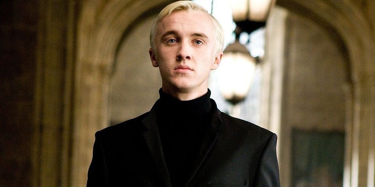 Draco Malfoy staring straight ahead in front of the Room of Requirement in Harry Potter