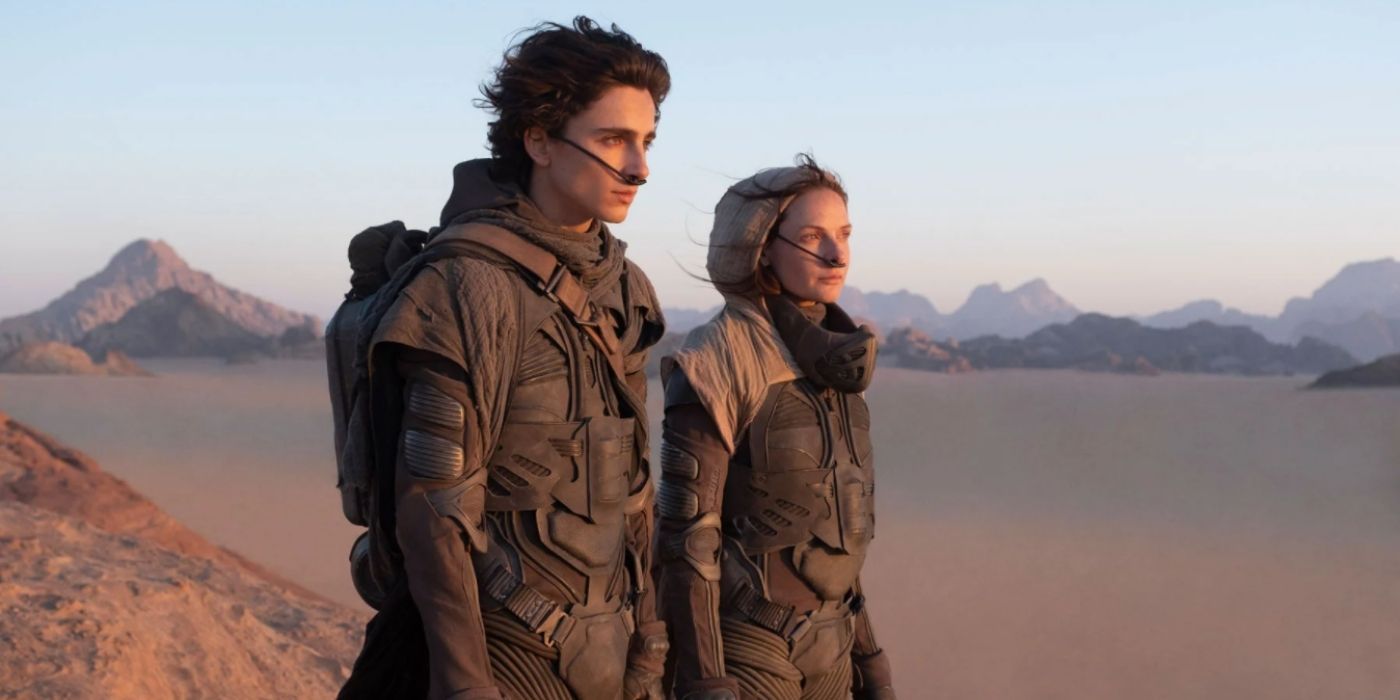 Paul and Lady Jessica look at the desert in Dune (2021).