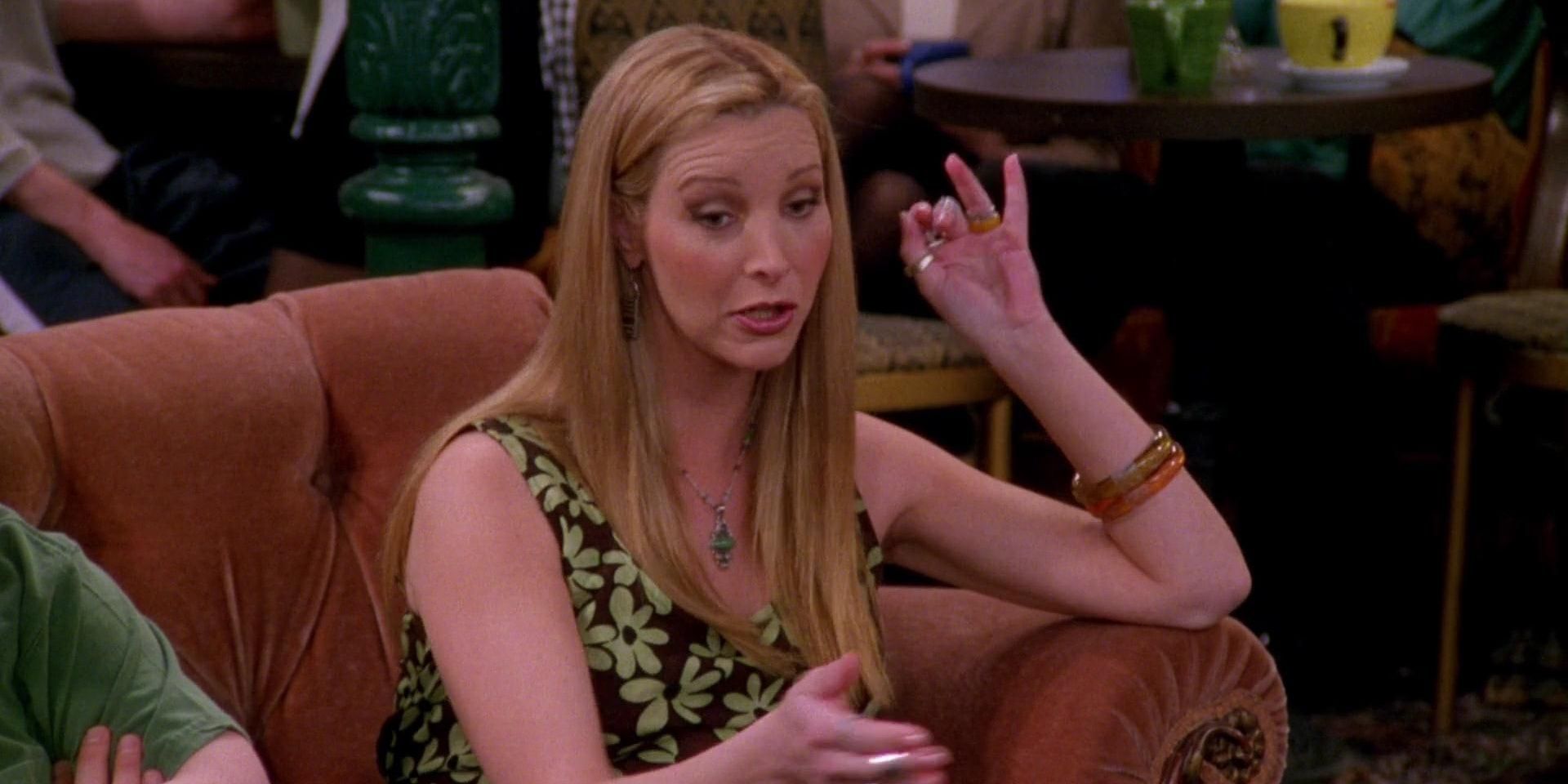 Phoebe Buffay (Lisa Kudrow)sitting on teh couch and talking in Friends.