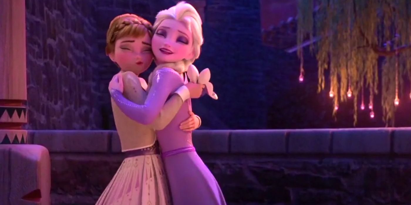 Anna and Elsa embrace on the stone walkway at the castle in Frozen 2