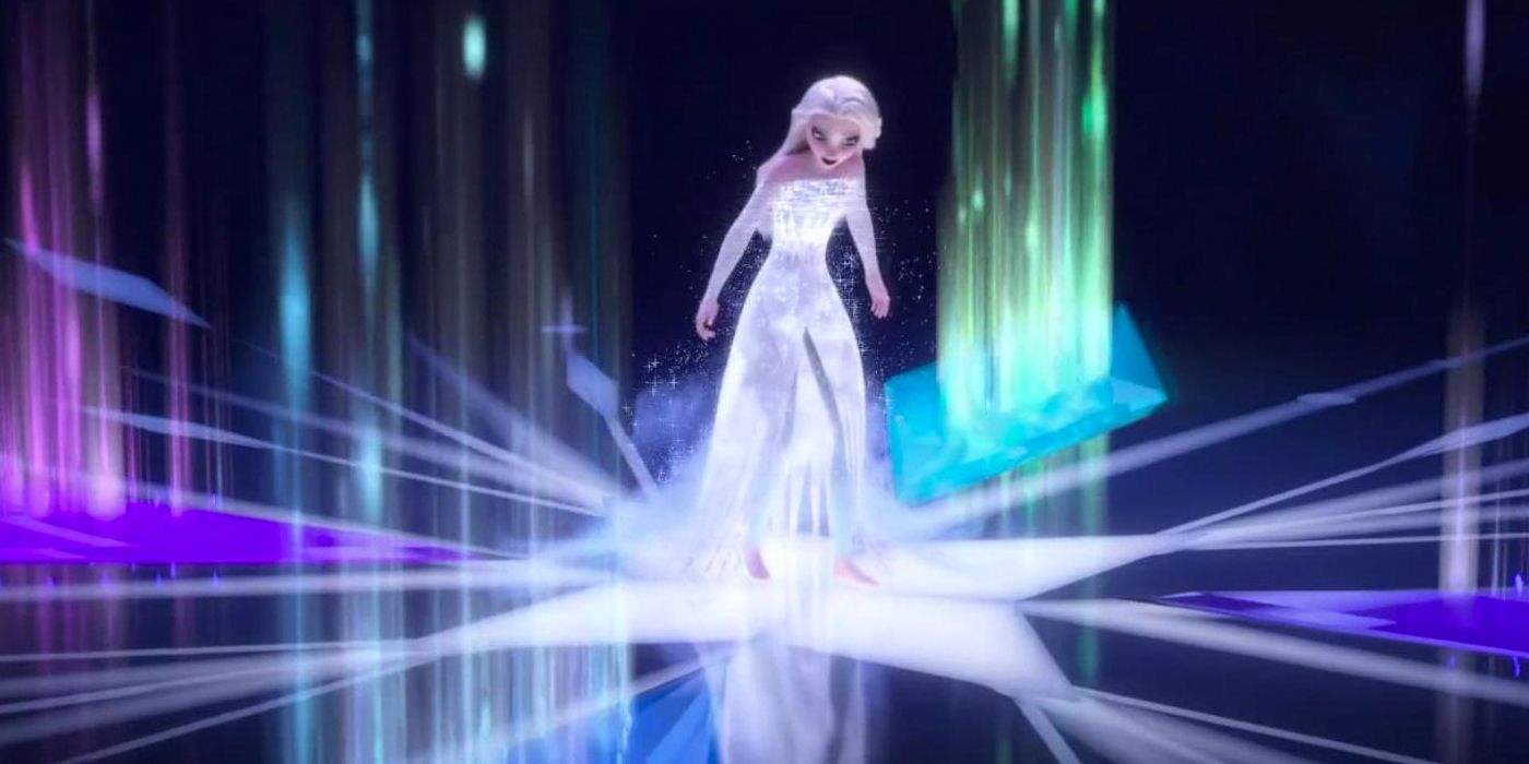 Elsa stands in the middle of snowflake shapes in various colors on the ground in Frozen 2