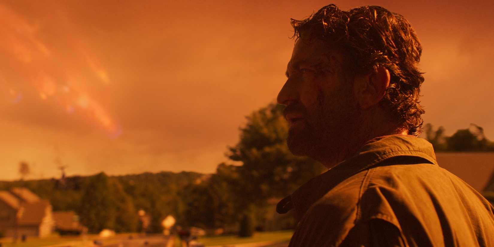 Gerard Butler is framed against a yellow sky looking dazed in Greenland