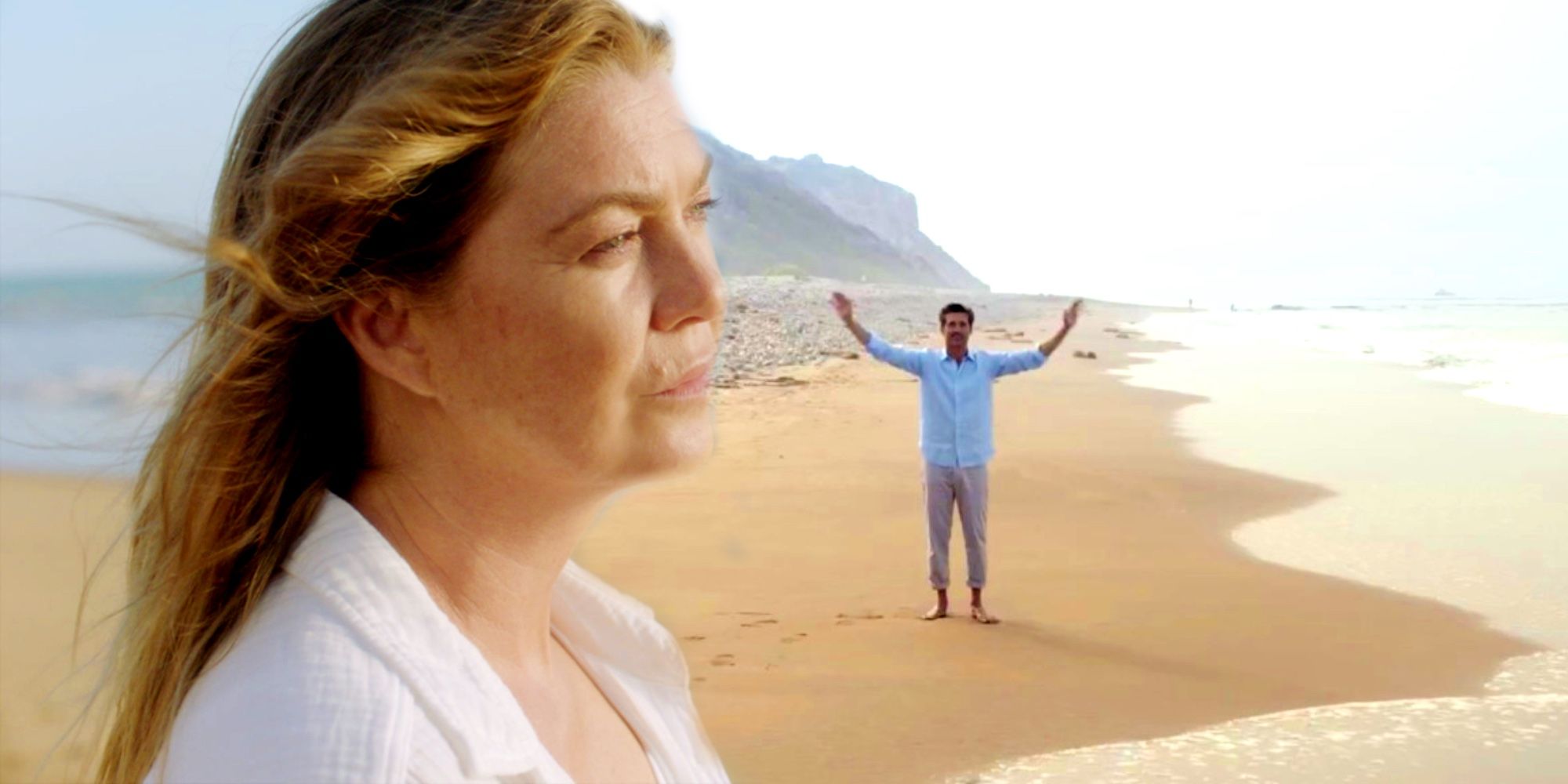 Meredith standing on the beach with Derek in the background on Grey's Anatomy