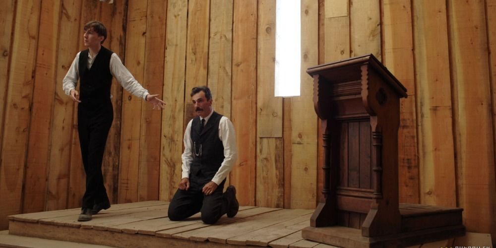 Daniel Plainview kneeling in Eli Sunday's church in There Will Be Blood
