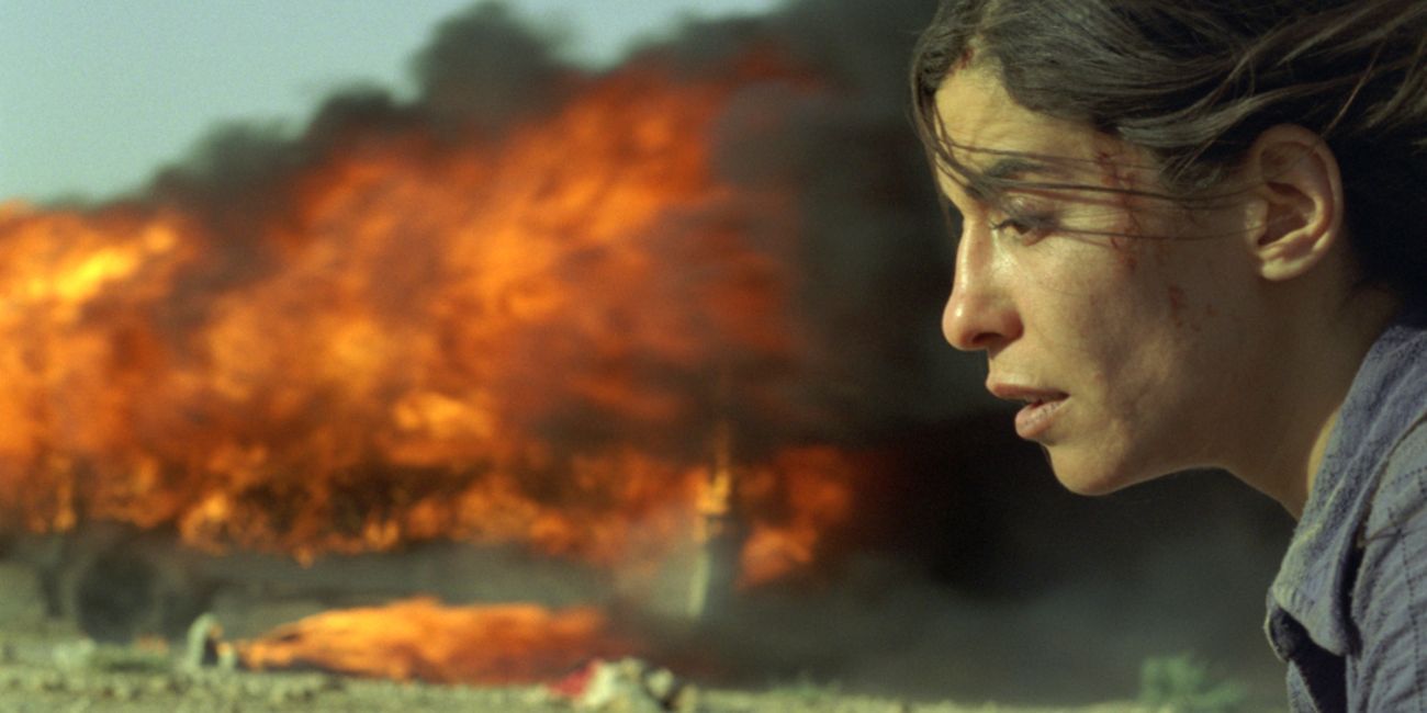 A woman kneeling besides an explosion in Incendies (2009).