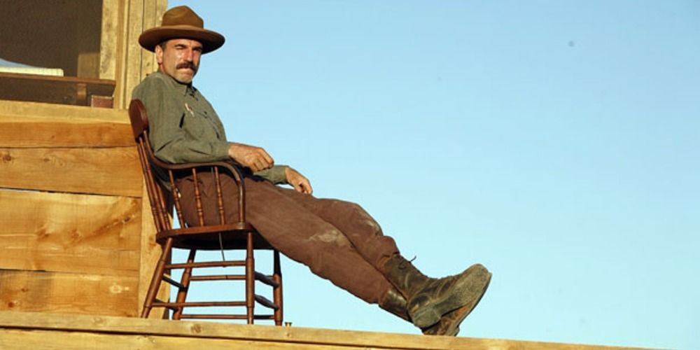 Daniel Plainview reclining in a chair in There Will Be Blood
