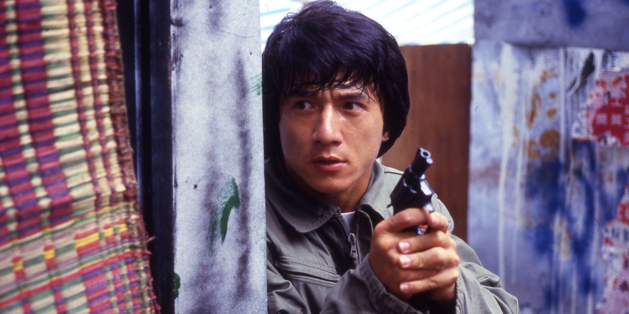 Jackie Chan holding a gun in Police Story