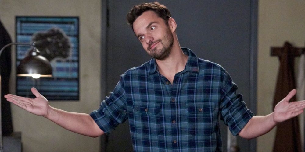 Nick Miller shrugs and smiles in New Girl