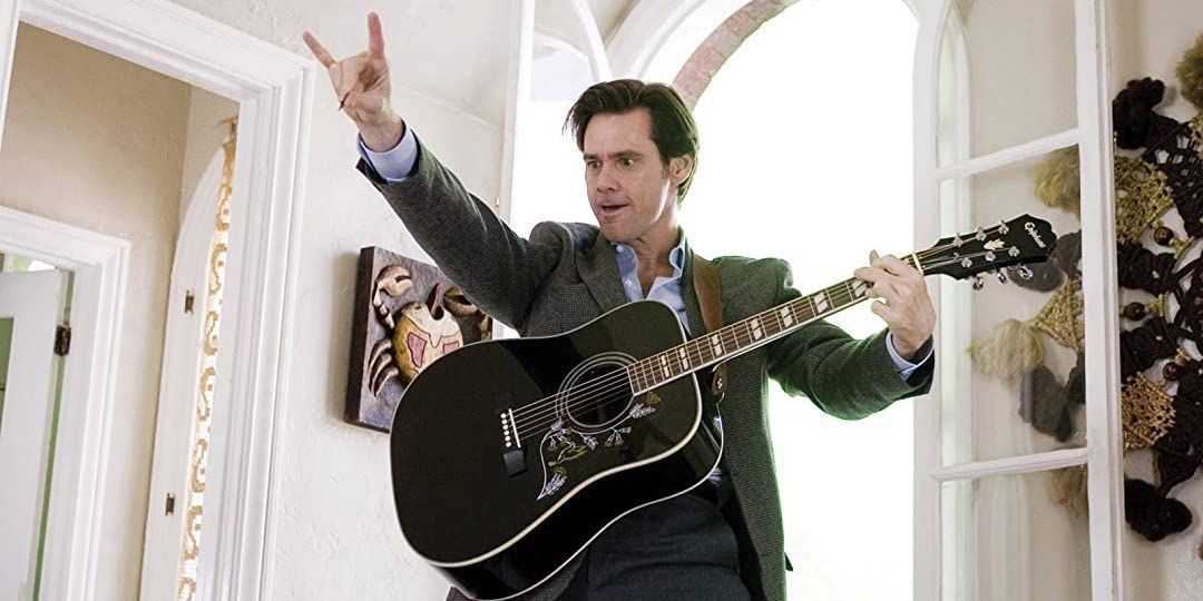 Jim Carrey playing an acoustic guitar in Yes Man