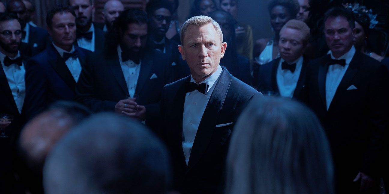 James Bond standing in a crowd of people in No Time to Die (2021)