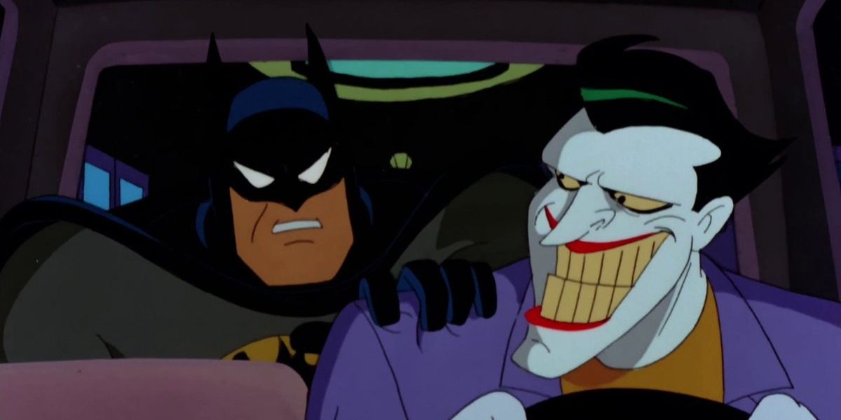 Joker grins at Batman in Batman: The Animated Series