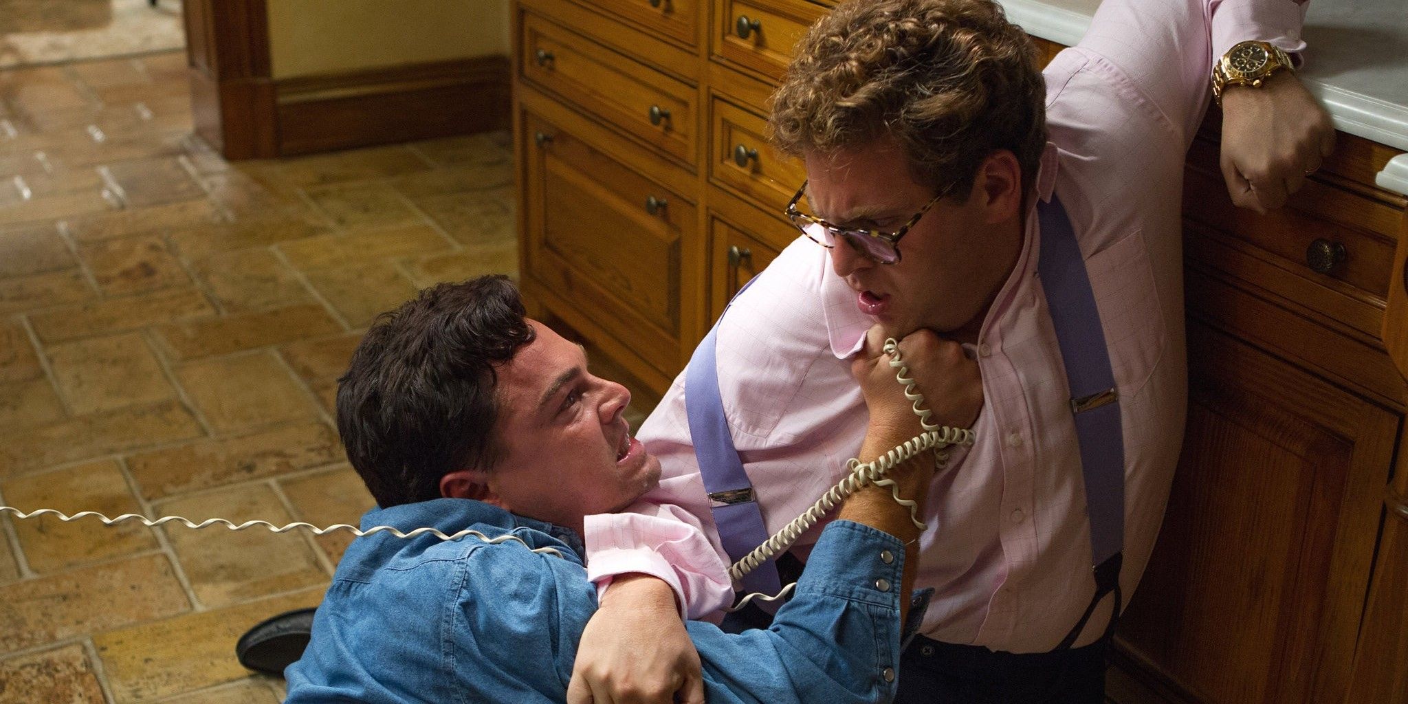 Jordan Belfort wrestles the phone off Donnie since the FBI is listening to the conversations 