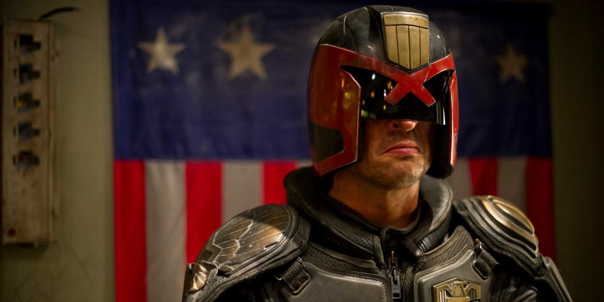 Karl Urban as Judge Dredd wearing iconic helmet menacing expression