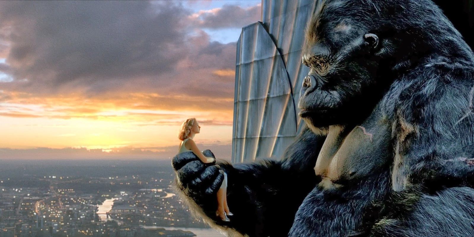 King Kong holds Ann Darrow while he sits on a skyscraper 