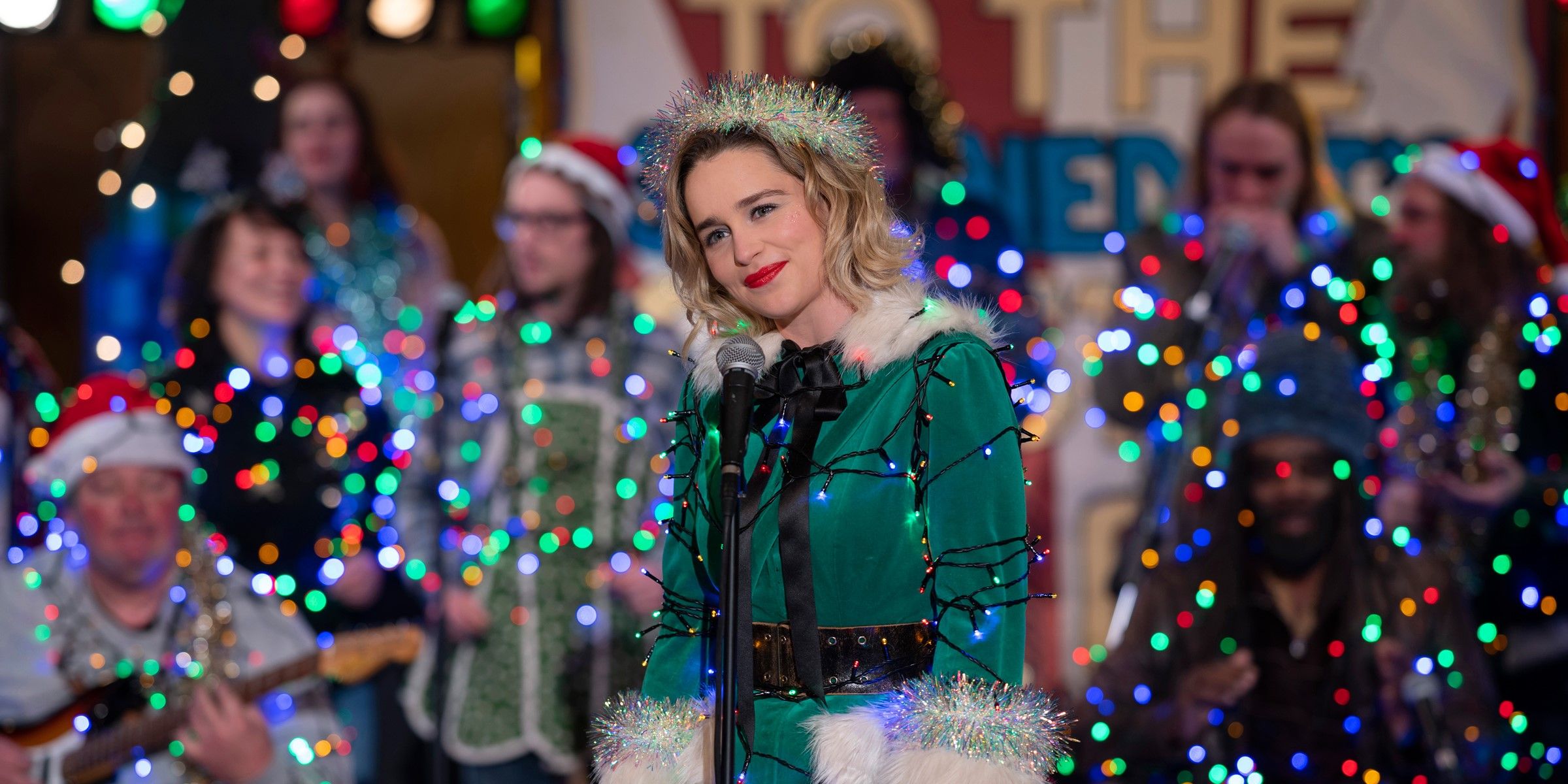 Kate on stage at the microphone in her Christmas lights in Last Christmas