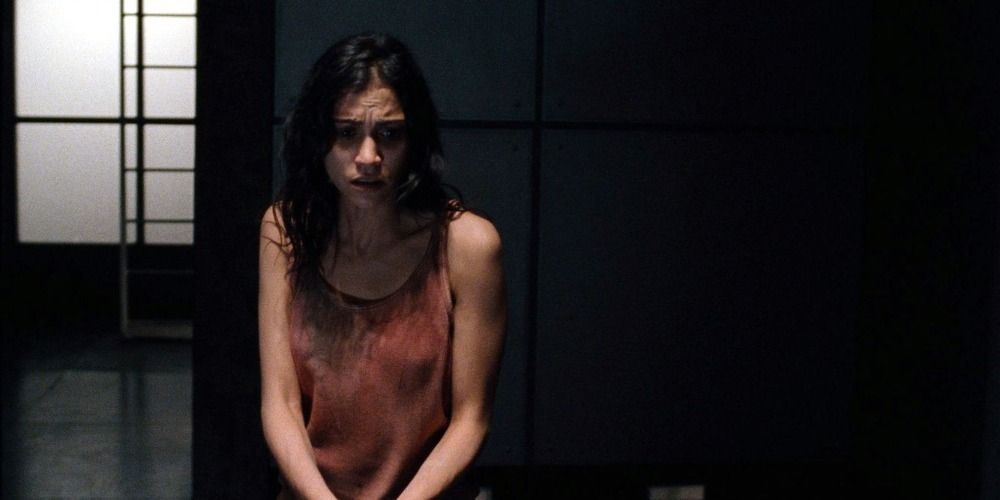 A close-up of the character Anna looking afraid in Martyrs