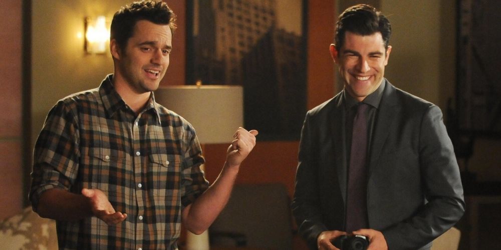Nick pointing his thumb at a smiling Schmidt in New Girl