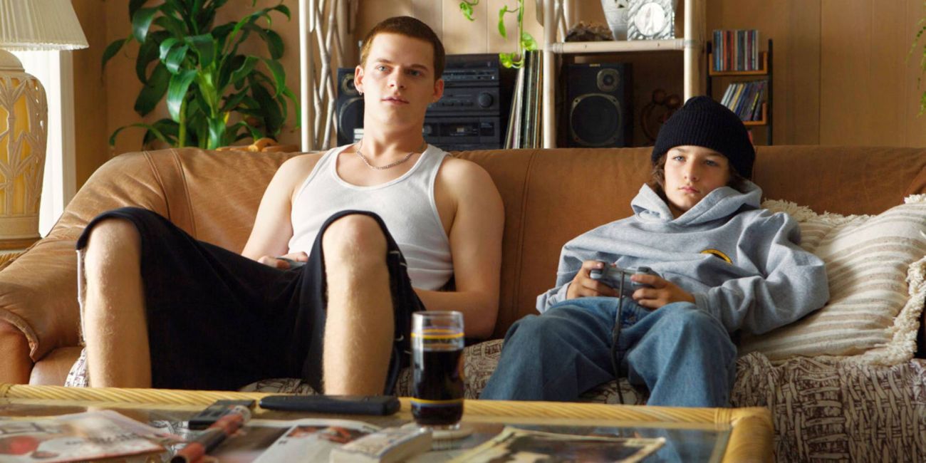 Two boys sitting in a couch playing videogames in Mid90s