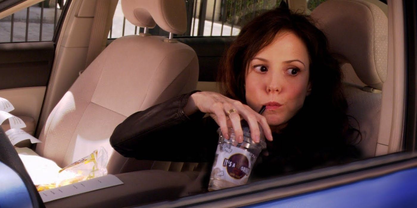 Nancy Botwin sitting in a car drinking from a straw in Weeds.