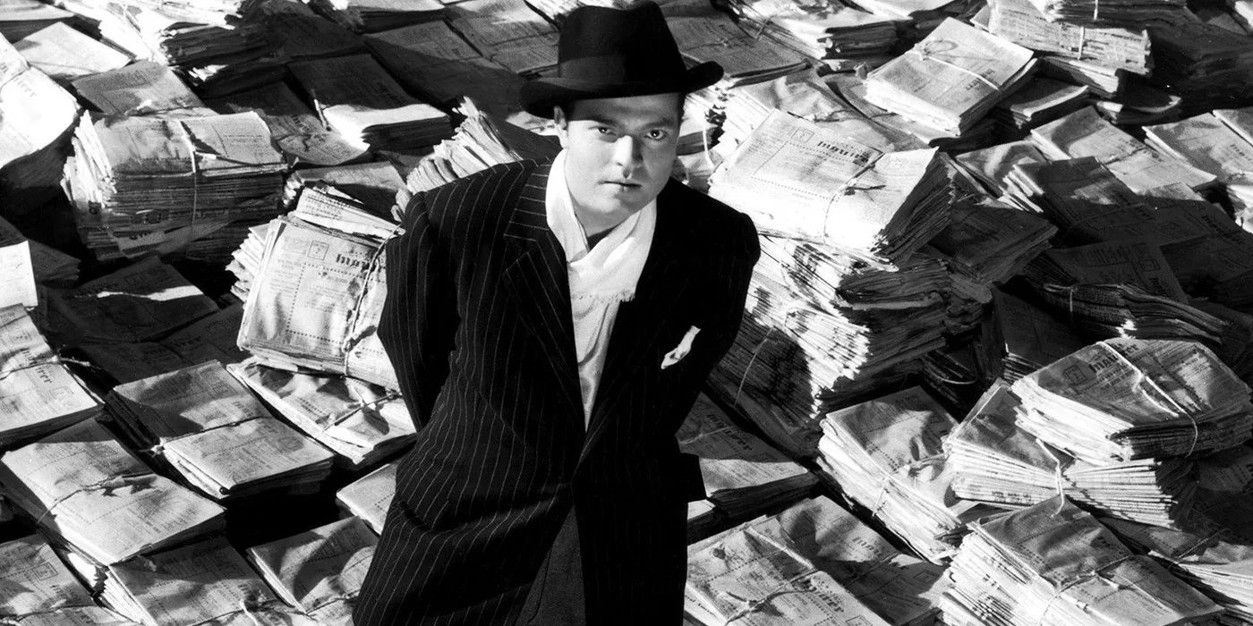 Orson Welles standing on newspapers in a still from Citizen Kane