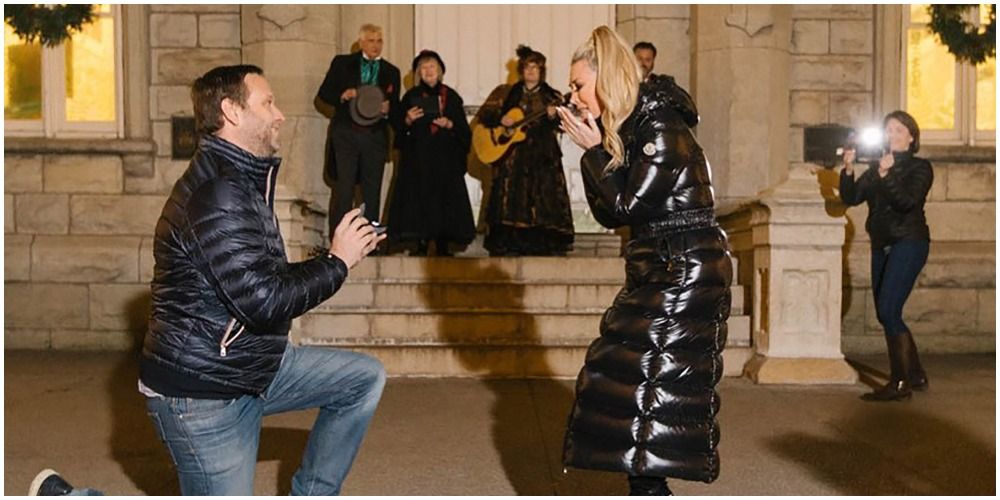 man proposing both man and woman in black coats